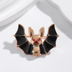 Gothic bat brooch with black wings and red eyes in a gold-tone finish for suits