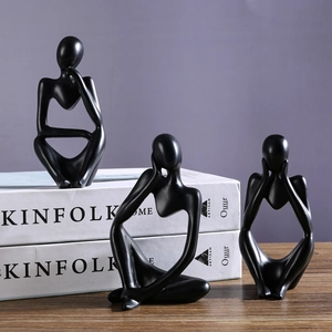 Nordic abstract black resin thinker sculptures set on a wooden table for home decor