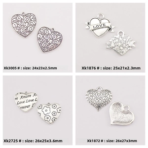 Macro view of vintage silver heart pendants for DIY jewelry with size specifications
