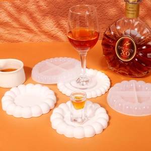 Detail of round bubble cloud coaster silicone mold with divided sections and finished resin crafts