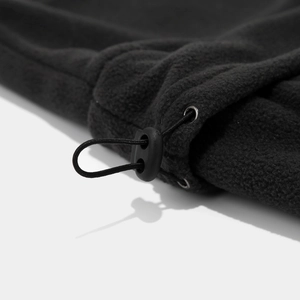Close-up of black fleece hood with adjustable elastic drawstring and plastic cord lock