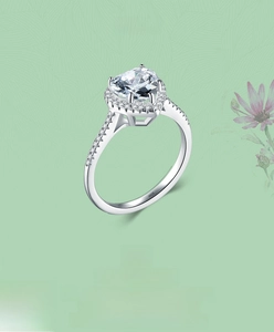 Detail shot of heart-shaped S925 sterling silver ring with halo setting and micro-pave diamonds