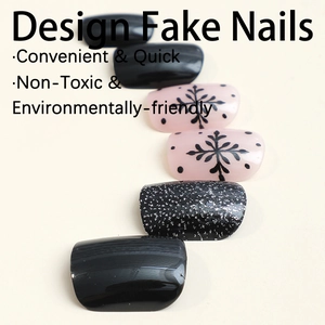 Black and pink press-on nails with snowflake patterns and glitter finish on a neutral base