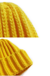 Close-up of bright yellow ribbed knit beanie showing high-quality texture and yarn detail