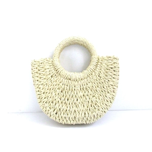 Detailed view of beige woven paper rope handbag with a minimalist round handle design