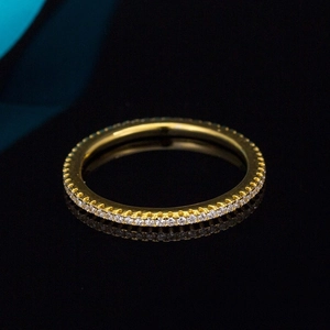 Macro shot of gold-plated sterling silver eternity ring with micro-pave diamond setting