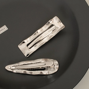 Minimalist silver geometric metal hair clips with wavy texture in rectangle and teardrop shapes