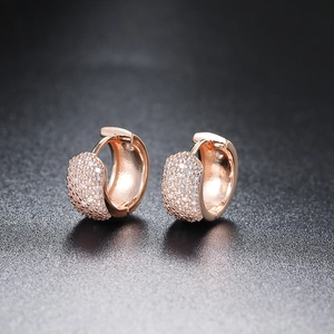 Macro shot of rose gold hoop earrings featuring five rows of micro-pave zircon stones