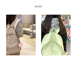 Detailed back view of minimalist beige and light green backpacks with cute peach charm