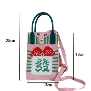 Pink knitted mini crossbody bag with green stripes and red bow detail, size 25x13cm