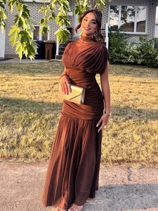 Close-up of ruched detail and high neckline on a dark brown mesh evening maxi dress