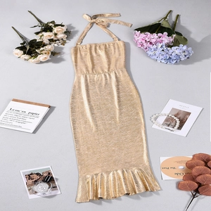 Detailed view of a gold halter neck mermaid dress with metallic texture and accessories