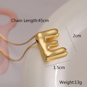 Detail shot of golden letter E balloon pendant showing 45cm chain length and 2cm size