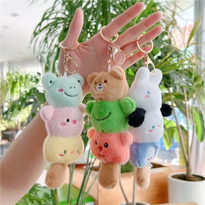 Three stacked cute plush animal charms including frog and bear with gold keychains