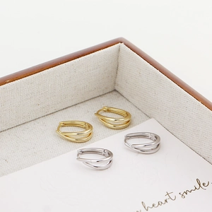 Detail view of U-shaped S925 sterling silver hoop earrings in gold and silver finishes
