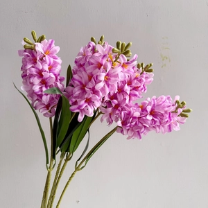 Detail view of pinkish purple artificial hyacinth flowers with realistic texture and leaves