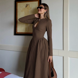 Detail of hollow keyhole neckline and pleated waist on dark brown long-sleeved dress