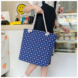 Detail of nautical anchor print canvas tote bag with thick rustic cotton rope handles