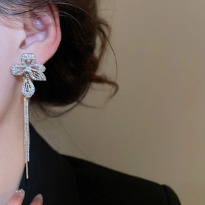 Detailed close-up of silver flower tassel earrings with shimmering cubic zirconia