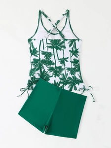 Detail of tropical palm tree print tankini top with adjustable side drawstring and green shorts