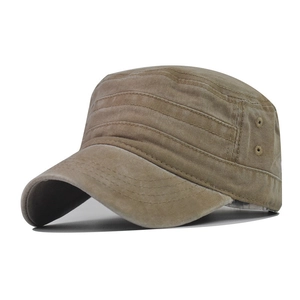 Detail of washed khaki cadet cap showing metallic eyelets and reinforced stitching