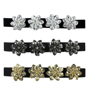 Three skinny elastic belts with crystal flower buckles in silver, gold and black
