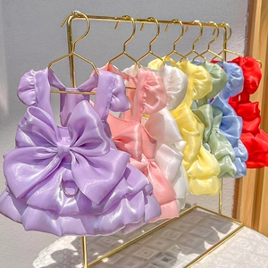 Detailed collection of satin pet dresses with bows and D-rings on gold hangers
