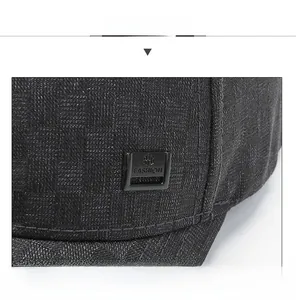 Detailed macro view of black knit baseball cap with checkerboard texture and fashion buckle