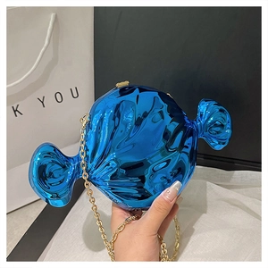 Close-up of candy-shaped acrylic bag in electric blue finish with gold chain