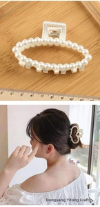 Detail view of 8.5cm large pearl hair claw clip shown with ruler and on model's hair