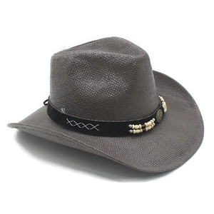 Detailed close-up of dark brown woven straw cowboy hat with leather band and bead accents