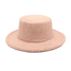 Detail showing the fluffy texture and soft pink faux shearling fabric of the winter hat