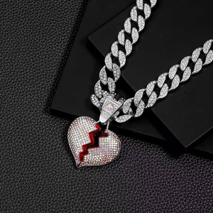 Silver Cuban chain necklace with iridescent rhinestones and broken red heart pendant