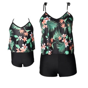 Two-piece family matching swimwear featuring tropical floral print tops and black swim shorts