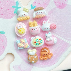 Macro view of assorted resin charms featuring cartoon bears and rabbit food designs