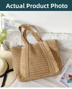 Detailed close-up of woven straw tote bag with decorative tassels for summer vacation