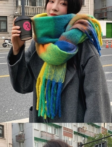 Close-up of thick rainbow mohair scarf featuring colorful knit texture and long tassels