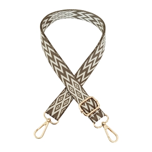 Detail of adjustable jacquard woven strap with taupe geometric patterns and gold clips