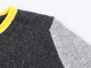 Close-up of color-block knit cardigan showing fuzzy texture and ribbed yellow neckline