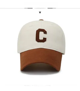 Close-up of contrast patchwork baseball cap with embroidered letter C patch