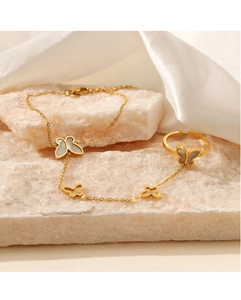 Detailed view of 18K gold butterfly hand chain set with white shell inlay