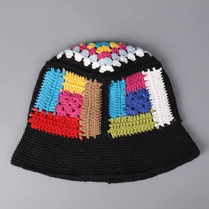 Close-up of handmade crochet bucket hat featuring colorful granny square patterns and black brim