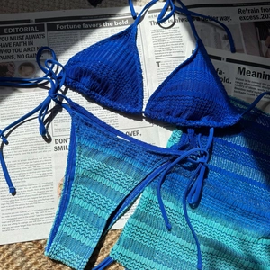 Detailed flat-lay of blue gradient knit bikini with wave texture and tie-side closure