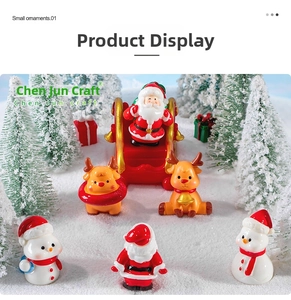 Miniature resin Christmas figurines including Santa and Reindeer on artificial snow