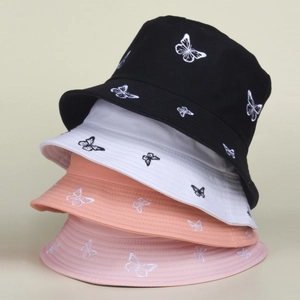Detailed embroidery of white and black butterflies on colorful cotton canvas bucket hats