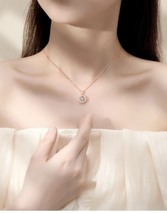 Close-up of S925 sterling silver flower necklace in rose gold worn by a model