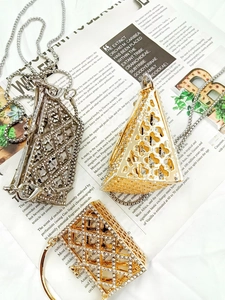Macro view of crystal rhinestone mesh crossbody mini bags in gold and silver finishes