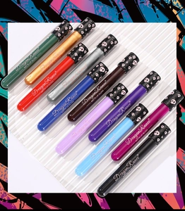 Macro shot of ten vibrant matte lip gloss tubes with skull patterns for Halloween
