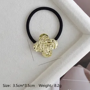 Close-up of golden metal floral hair tie with 3.5cm size and 8.2g weight details