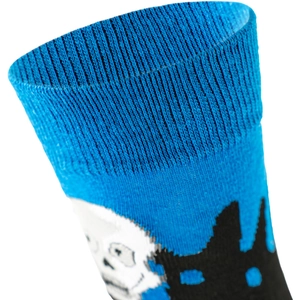 Detailed macro view of blue knitted socks featuring skull patterns and elastic cuff texture